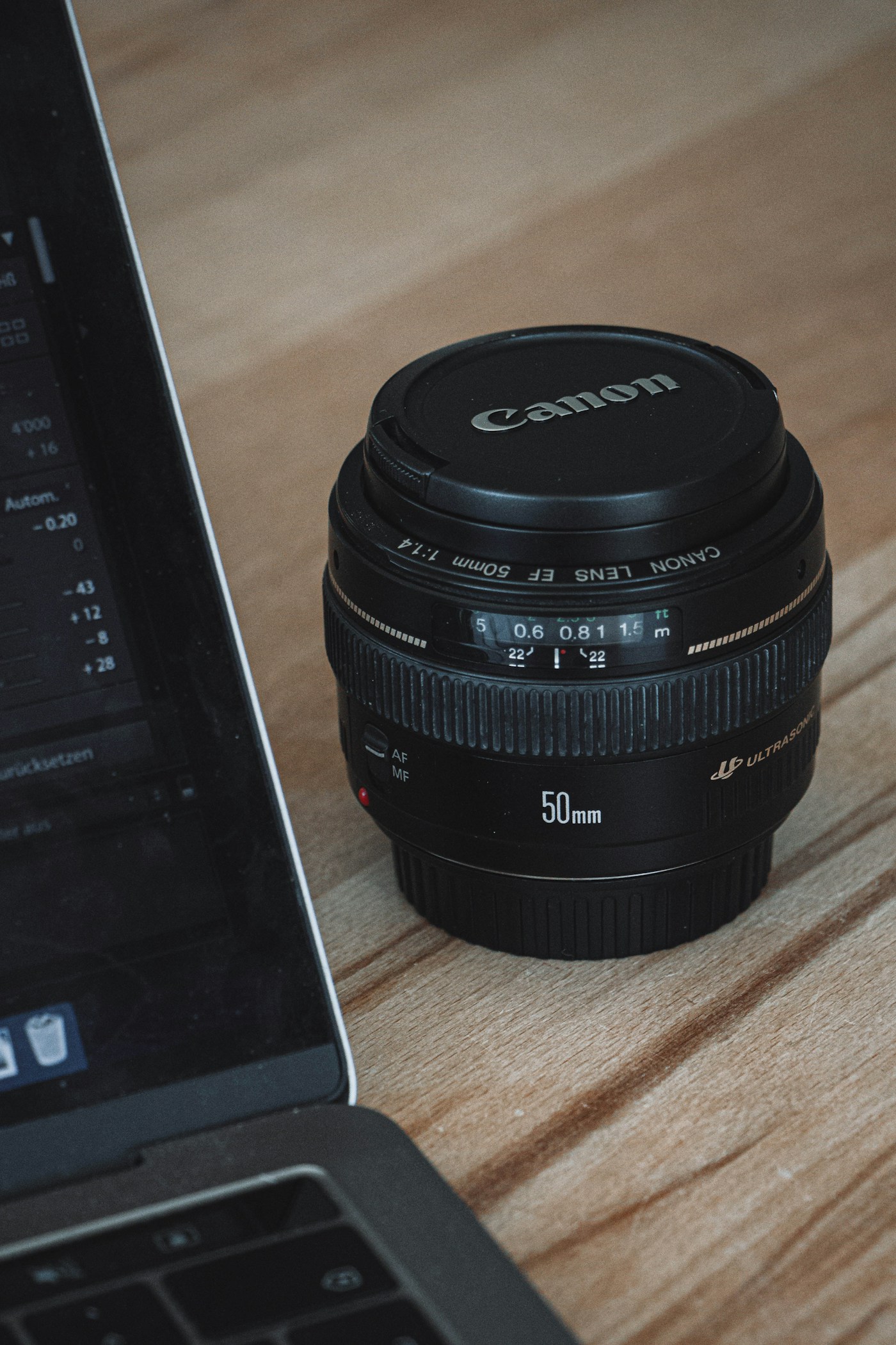 Home Close-up of a camera lens beside a laptop