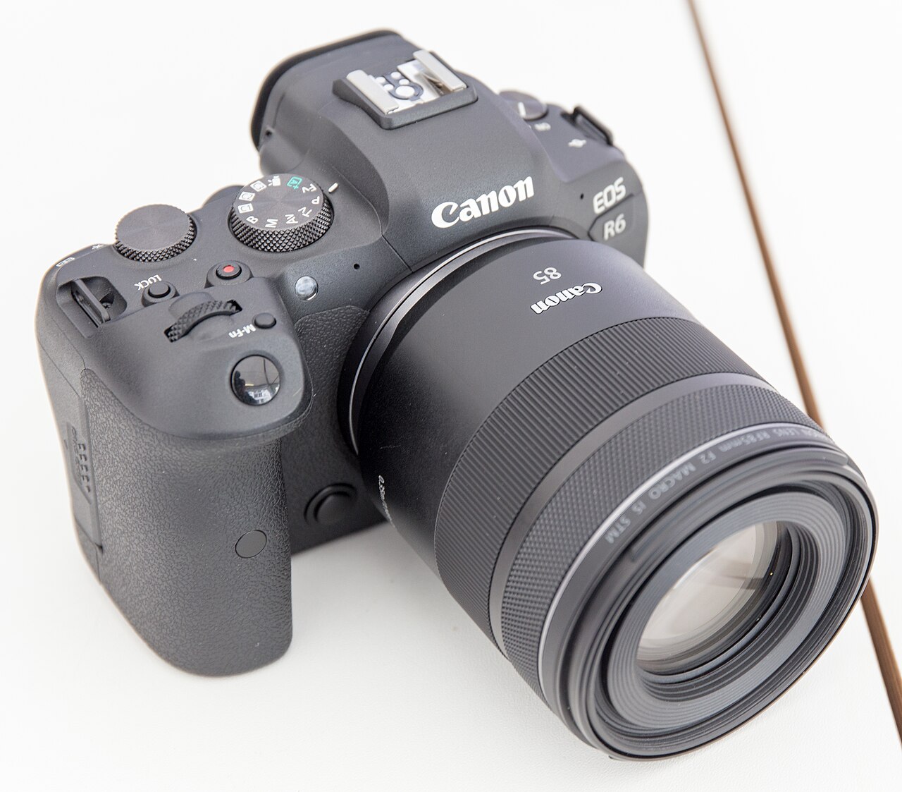 Cameras Canon EOS R6 with Canon RF 85mm F2 lens on a light tabletop