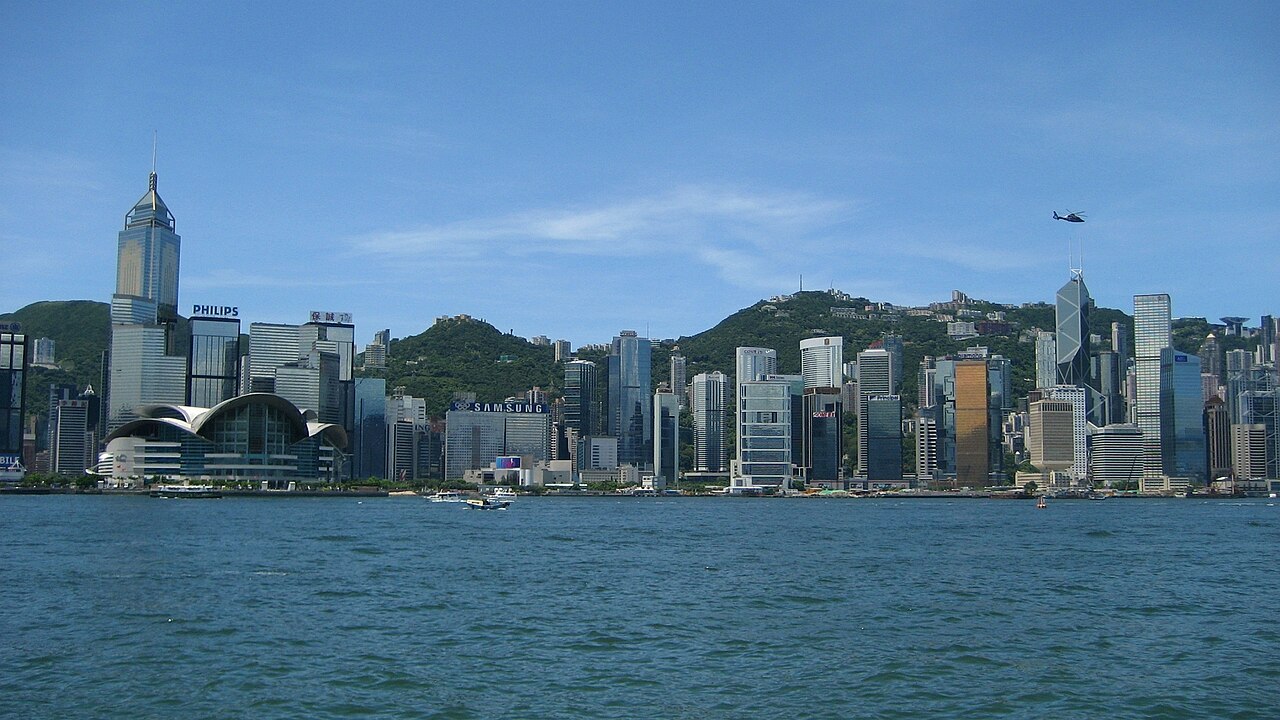 About Daytime Victoria Harbour view towards Wan Chai and Central, with the convention centre and Bank of China Tower